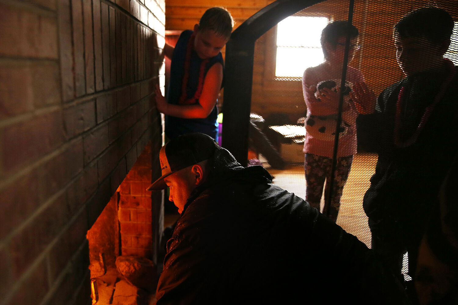 Bryce McKenzie works to build a fire
